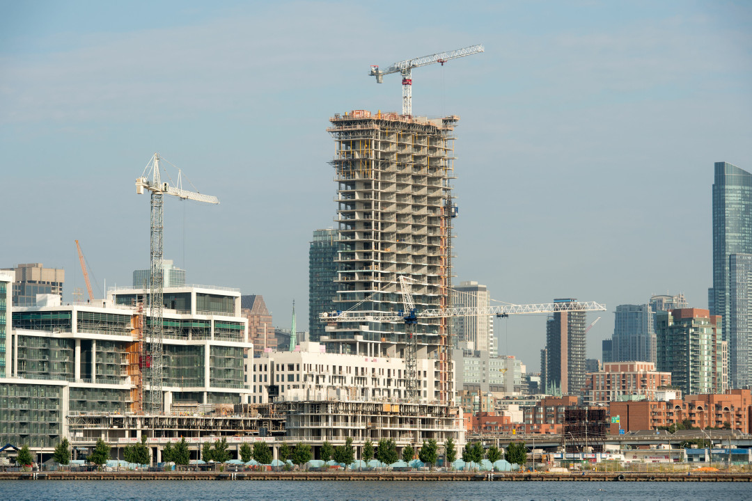 A view of cranes and buildings being built along the waterfront in Toronto.